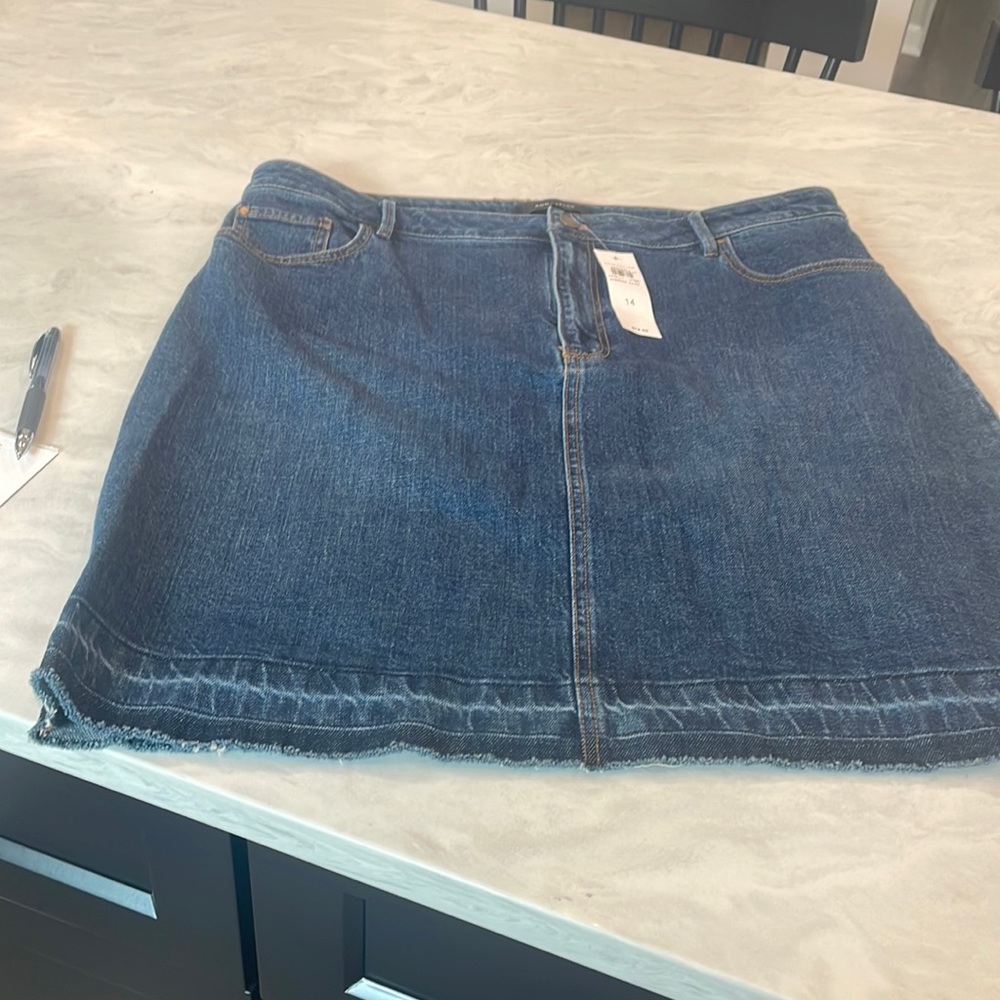 Ann Taylor Denim skirt - new with tags. Hits right above knee.  Cute hem detail